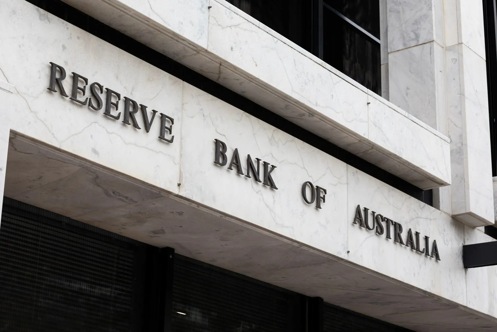 The Reserve Bank of Australia sign on a white marble facade